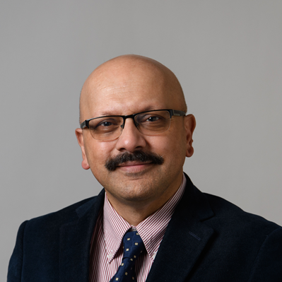 headshot of man in black blazer