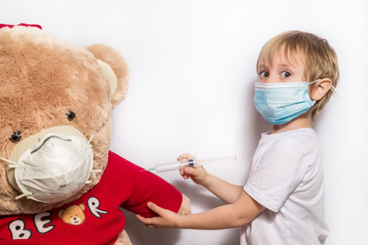 child vaccinating teddy bear