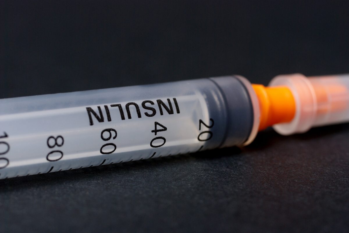 Image showing insulin syringe against a black background.